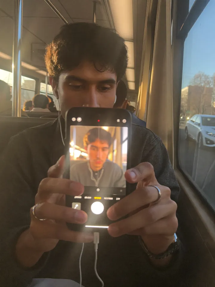 Creator editing a video on his phone on the bus