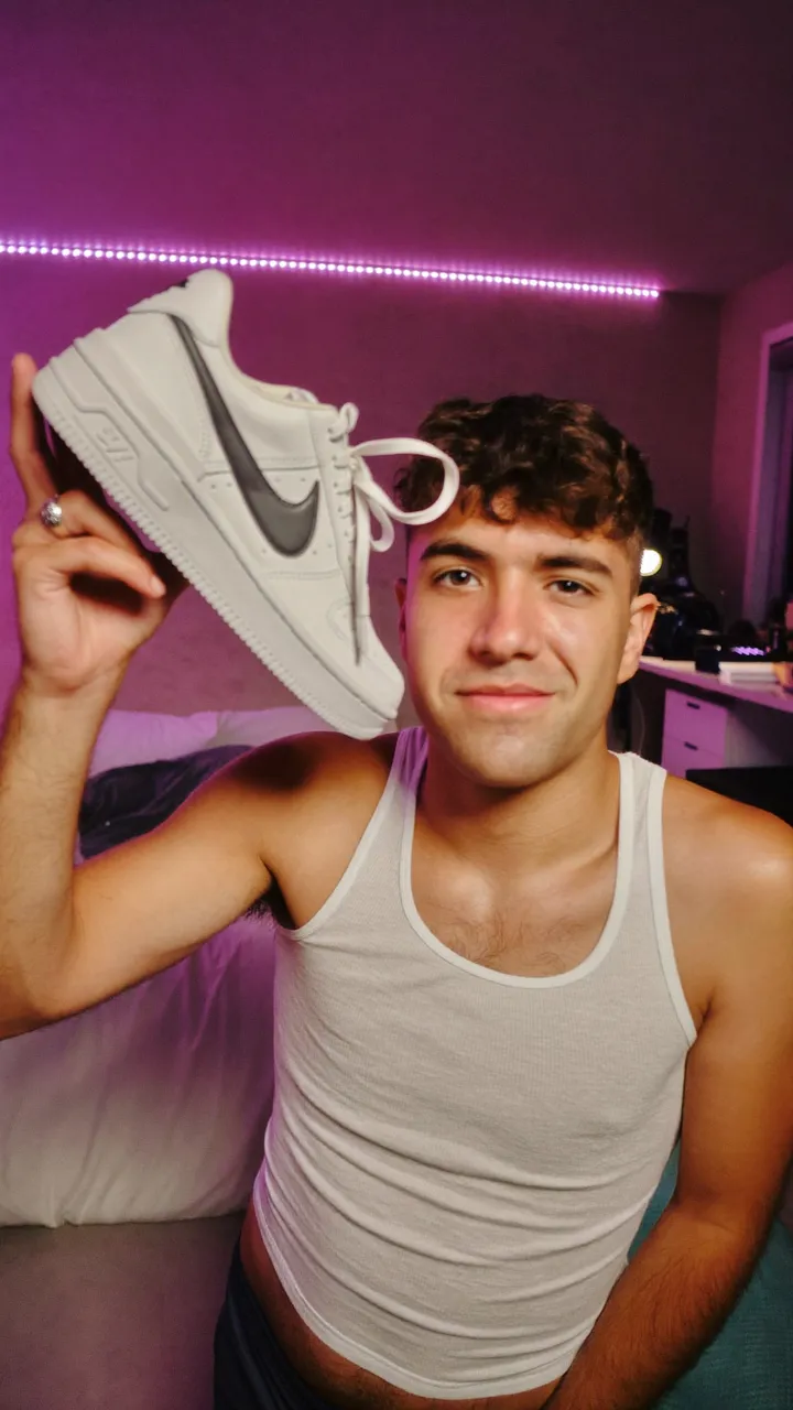 Creator showing sneakers to the camera in his room